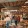 people walking in a large room with tables and chairs